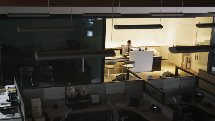 Young manager working alone in an empty office, elevated view