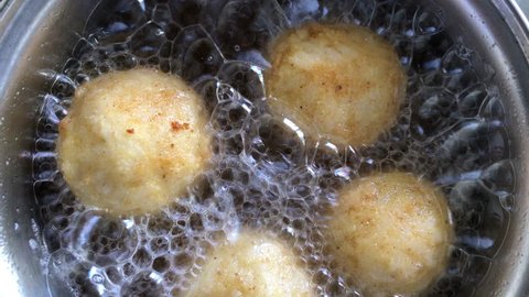 Frying rice balls stuffed with cheese filling, traditional French boulette de riz