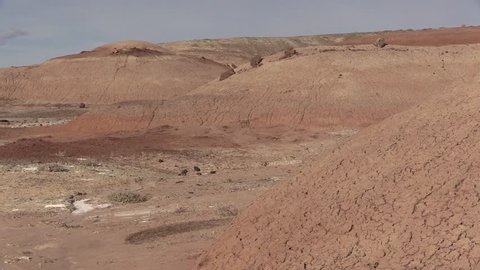 An astronaut in a simulated Mars mission exploring Mars-like red bentonite landscape in Utah near Mars Desert Research Station