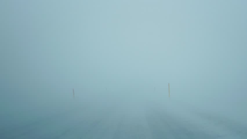 Extreme driving conditions trough strong blizzard Mountain road Very poor visibility View from inside car Iceland Royalty-Free Stock Footage #1016814841