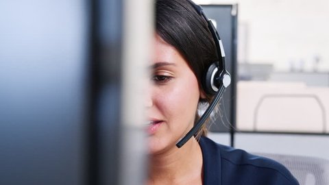 Young mixed race woman working in call centre