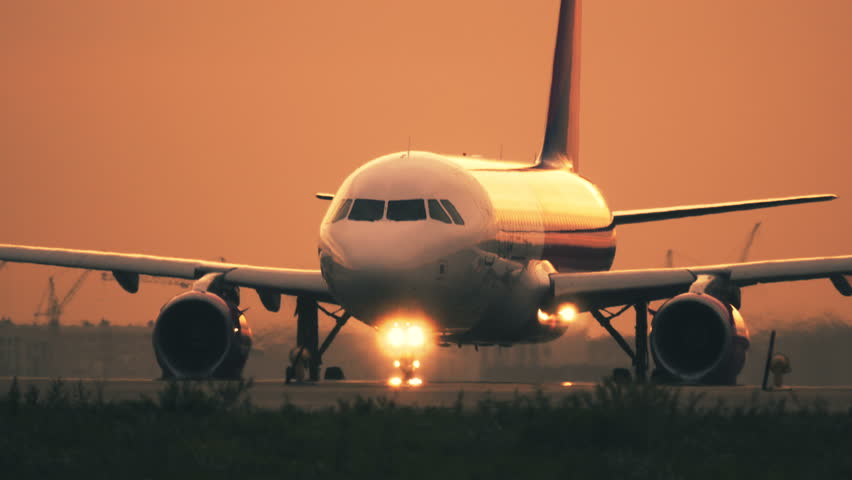 Turbo airplane is taxiing on the taxiway after landing at sunset Royalty-Free Stock Footage #1016820802