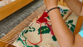 Woman weaving a rug on a wooden loom, 4k Video Clip