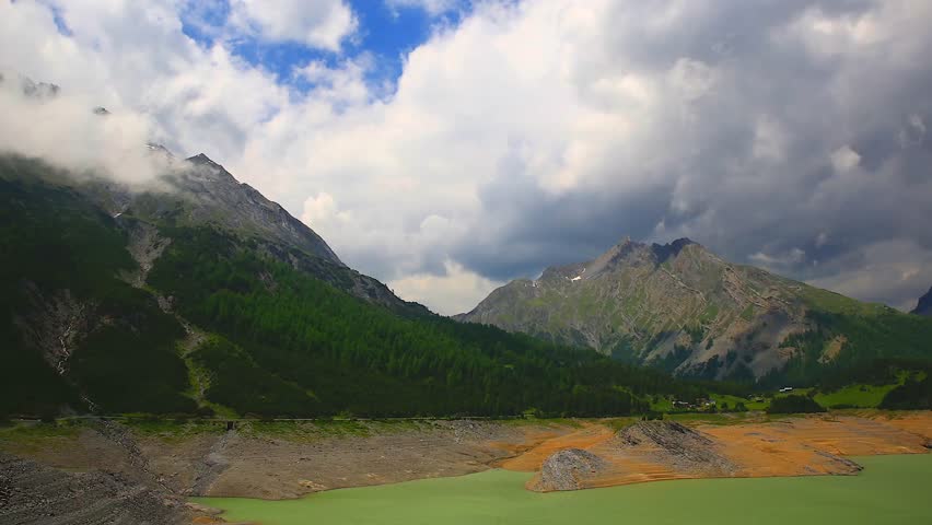 Mountain landscape with lake and clouds, 4k time lapse