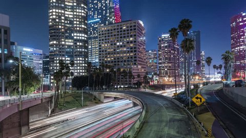 Los Angeles, California, USA - September 11th 2018 - Downtown Los Angeles Traffic and Buildings with Palm Trees at Night Timelapse