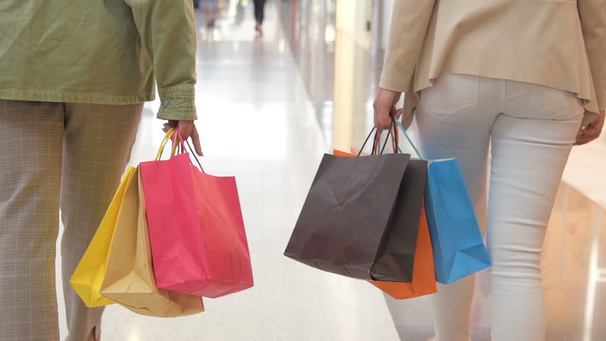 Legs of shopaholics with shopping bags walking down mall. slow-motion. Female women walking at shopping mall. | Shutterstock HD Video #1016833492