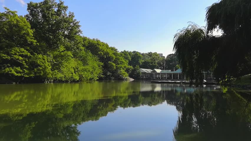 A slow pan from left to right of the Lake at Central Park in Manhattan, New York on a sunny summer morning.