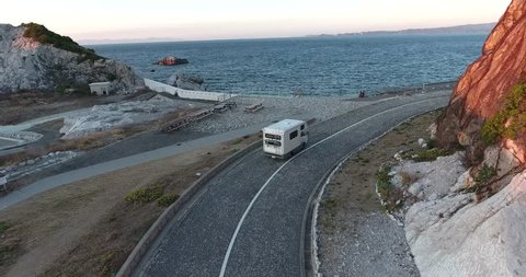 Aerial view RV, cars passing Bridge on Highway  with Ocean,lake in background. japan camping ground