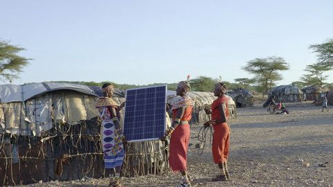 Tribal women installing solar panel. Kenya