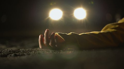 Unconscious victim lying on road, automobile driving after road accident, crime