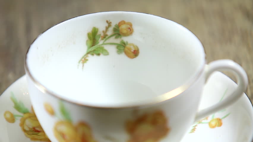 Tea cup being filled with hot tea