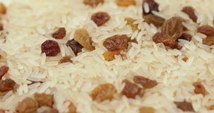 Mixture of rice and raisins. Video shot with rotation