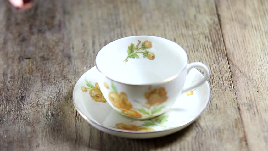 Tea cup being filled with hot tea