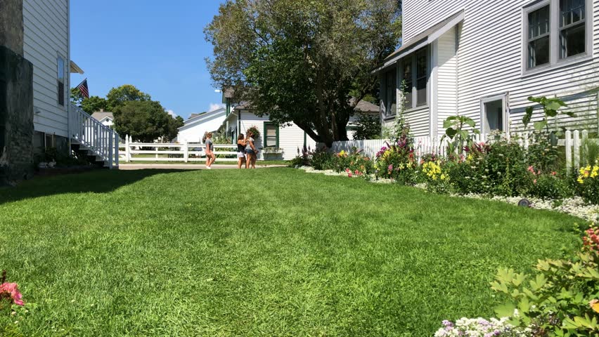 Motion time lapse of flower garden and passersby on Mackinac Island, Michigan USA