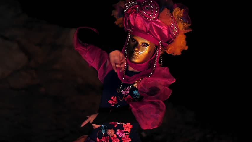 The face of the girl at the masquerade in a Venetian suit hides a mysterious mask. Dance with fire in the night. Concept idea for dance Royalty-Free Stock Footage #1016862856