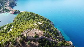 Aerial drone bird's eye view video of iconic medieval castle in picturesque colorful traditional fishing village of Assos in island of Cefalonia, Ionian, Greece