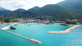 Aerial drone video of iconic seaside village and port of Vasiliki famous for trips to Ionian islands and nearby beaches, Lefkada island, Ionian, Greece