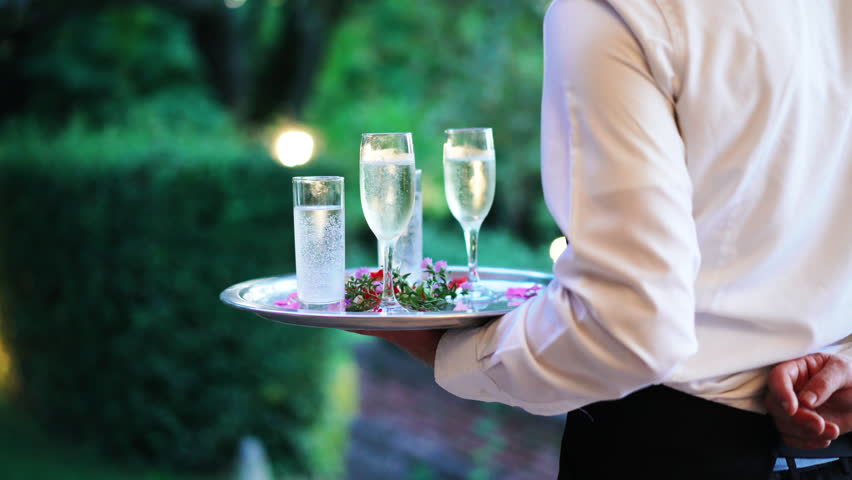 Waiter and champagne glasses on a tray in Luxury Restaurant. Catering service. 4k Royalty-Free Stock Footage #1016867023