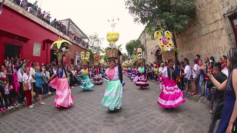 Oaxaca, Mexico - July 23, 2017: Slow motion of dancers from Chinas Oaxaqueñas in the parade before Guelaguetza festival. Is an annual indigenous cultural event with traditional dancing and costume.