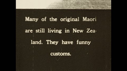 1930s: Intertitle. Men in Maori dress dancing.