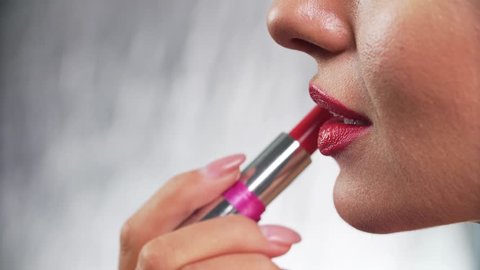 Red Lipstick. Woman Applying Lipstick On Full Sexy Lip Closeup
