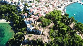 Aerial drone bird's eye view video from iconic and picturesque village of Parga with famous medieval uphill castle, Epirus, Ionian, Greece