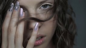 Attractive young girl with NailArt . Video of beautiful girl with perfect skin and amazing manicure.