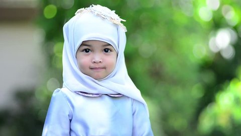 Close up of Asian Muslim cute girl or kid wearing Hijab and giving her beautiful smile to all people. The concept is smiling and happiness