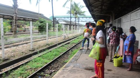 BAGO, MYANMAR - JULY 13 : Burmese people and foreigner traveler waiting train at railway station on July 13, 2014 in Bago, Burma.