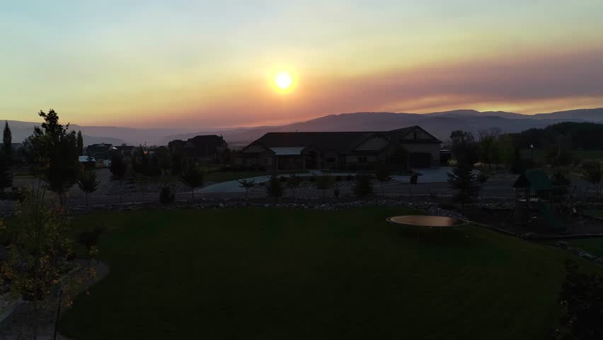 A beautiful aerial shot of a sunrise with very smoky skies from a nearby wildfire