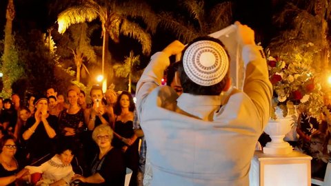 Tel Aviv, Israel - June 29, 2016: Jewish traditions wedding ceremony. The bridegroom covers the bride's face with a wedding veil