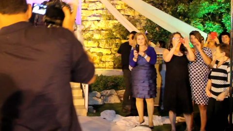 Tel Aviv, Israel - June 29, 2016: Photographers and video operators on traditional Jewish wedding with a chuppah or huppah. Selective focus.