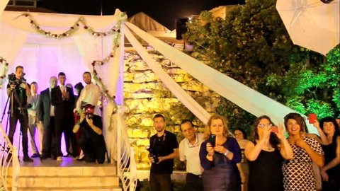 Tel Aviv, Israel - June 29, 2016: Jewish traditions wedding ceremony. The bride parents go to the chuppah