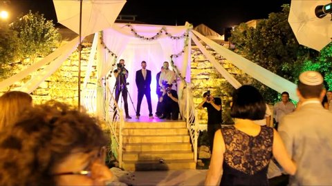 Tel Aviv, Israel - June 29, 2016: Jewish traditions wedding ceremony. The groom, accompanied by his parents, goes to the chuppah