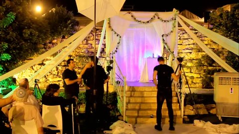 Tel Aviv, Israel - June 29, 2016: Photographers and video operators are preparing for a traditional Jewish wedding with a chuppah or huppah