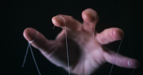 Manipulation concept with puppet string and controlling hand