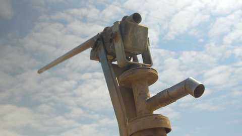 Silhouette of a Hand Pump Well in Africa, Blue Sky Background