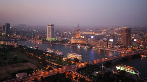 CAIRO, EGYPT - AUGUST 4, 2009 Time Lapse Aerial View of Cairo City Skyline Cars Traffic on Road Dusk to Night