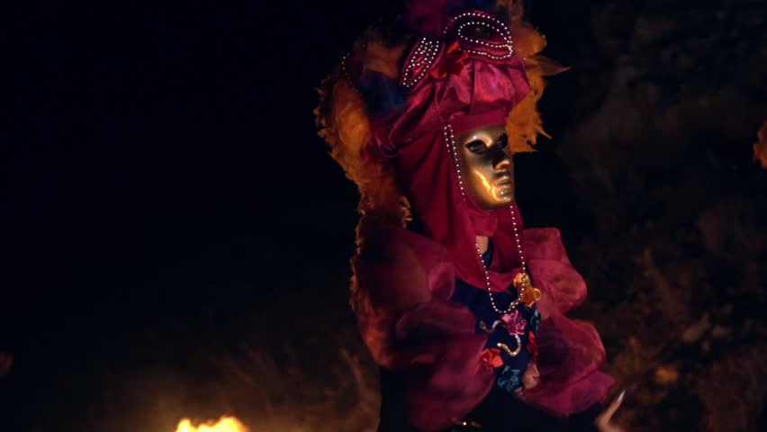 The face of the girl at the masquerade in a Venetian suit hides a mysterious mask. Dance with fire in the night. Concept idea for dance Royalty-Free Stock Footage #1016919889