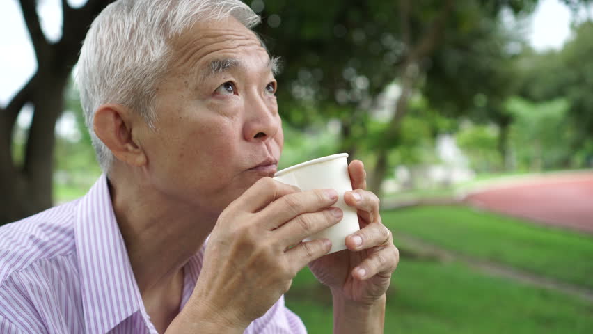 Elder drink. Asian Senior. Middle age Asian man smoking.