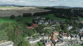 Aerial footage of the historical village of Culross on the North shore of the River Forth. White-harled houses, red-tiled roofs and cobbled streets. A location for the hit television series Outlander.
