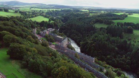 Lanark, Scotland, UK; September 24th 2018: Aerial footage over the village of New Lanark. A World Heritage Site in a deep valley next to the River Clyde.
