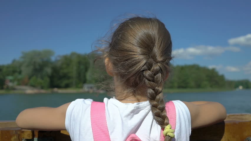 Little girl admiring the coastline of aboard a boat. Boating among the Islands of southern Finland in the Baltic sea.