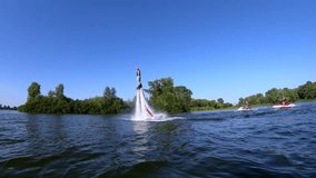 Two Flyboarders diving slow motion into the water doing tricks Flyboarding wide shot video
