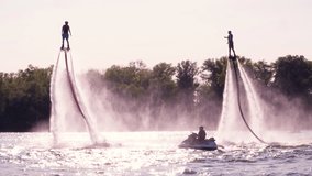 Two Flyboarders flying slow motion against the sun Contre-jour backlighting Flyboarding video