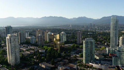 Aerial view of a modern city during a vibrant summer sunset. Taken near Metrotown, Burnaby, Greater Vancouver, BC, Canada.