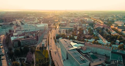 Slow, forward tracking shot of downtown Helsinki during golden hour from an aerial POV.