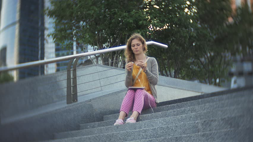 Young hipster woman is strolling in the city park business center 4k