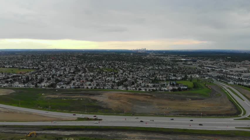 Aerial drone footage of Calgary, Alberta city landscape at sunset framed with main highway. 4k.