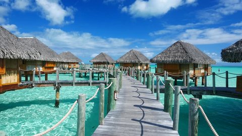 Luxury overwater villas on blue lagoon, white sandy beach and Otemanu mountain at Bora Bora island, Tahiti, French Polynesia
 Video Stok
